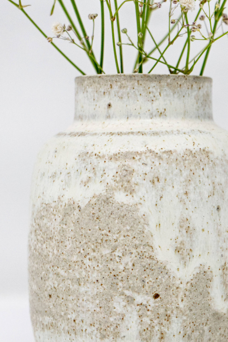 A close-up shot of a white speckled vase.