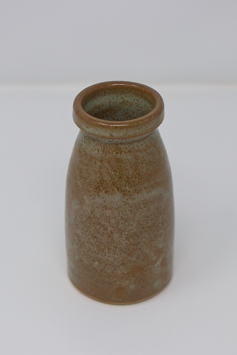 A small, brown speckled vase.