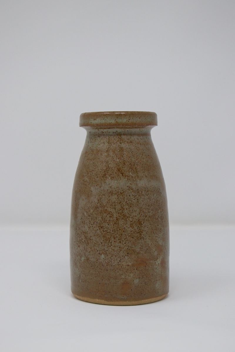 A small, brown speckled vase.